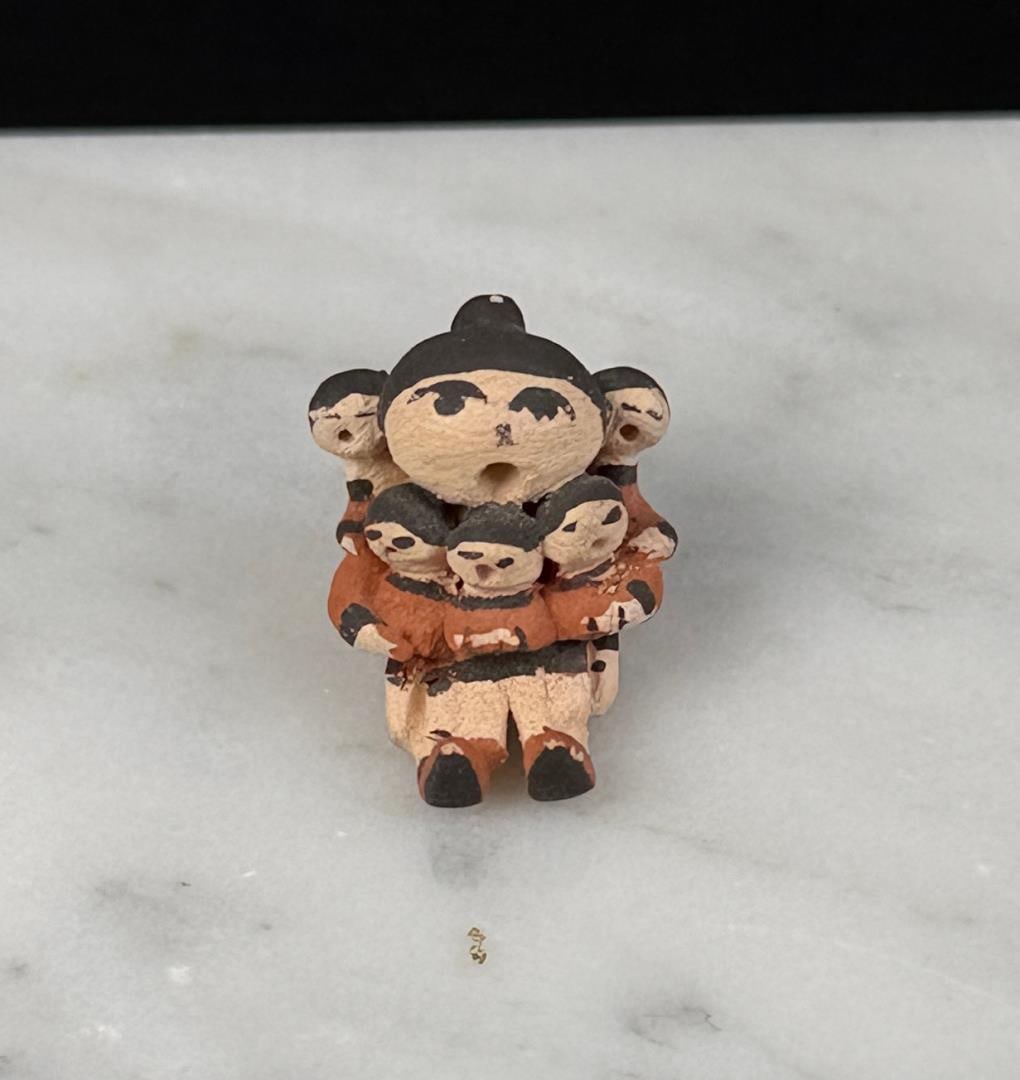 Judy Shields Acoma Pueblo Miniature Storyteller: 1/2" by 1/2" by 3/8".
