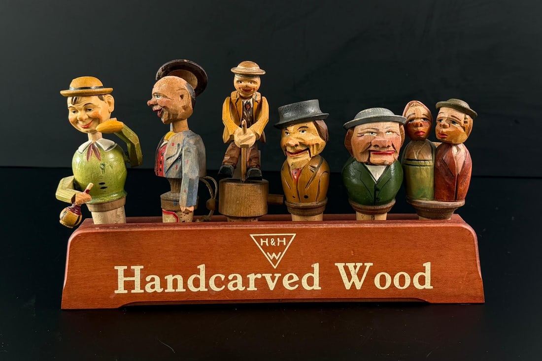 Anri Carved Wood Mechanical Bottle Stopper Set: 10 7/8" by 6" by 3" with stoppers.