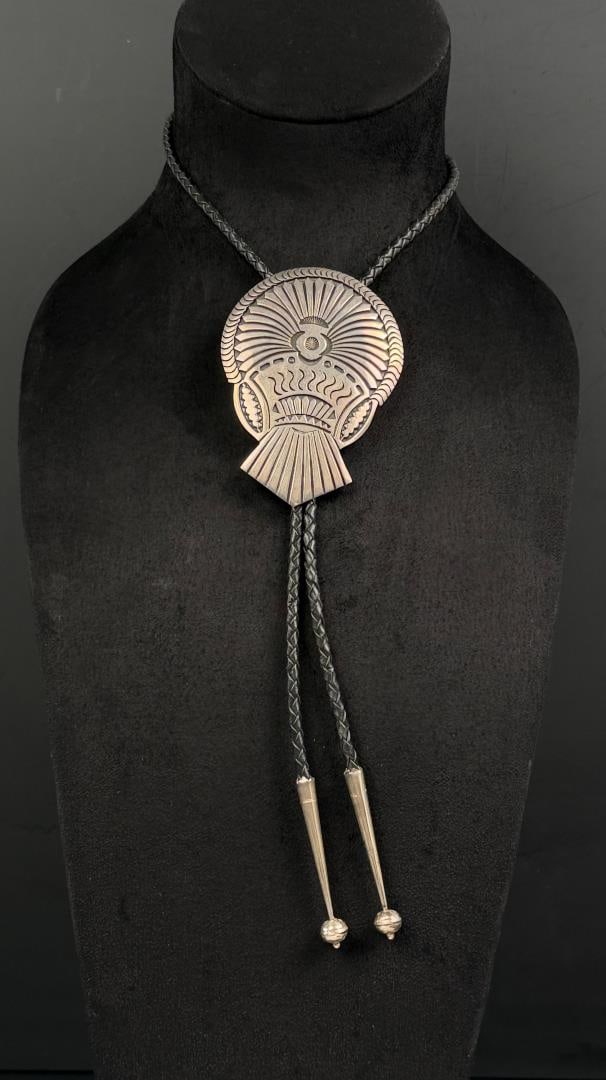 Emerson Bill Navajo Sterling Silver Bolo Tie: 103.85 grams total with leather braid. 22 7/8" long.