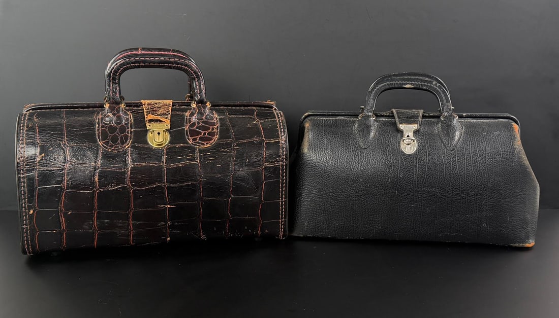 Pair of Antique Leather Montana Doctors Bags: The Crocodile Pattern Leather bag is 6 3/4" by 8 5/8" by 15 1/8" and is Swiss Made.