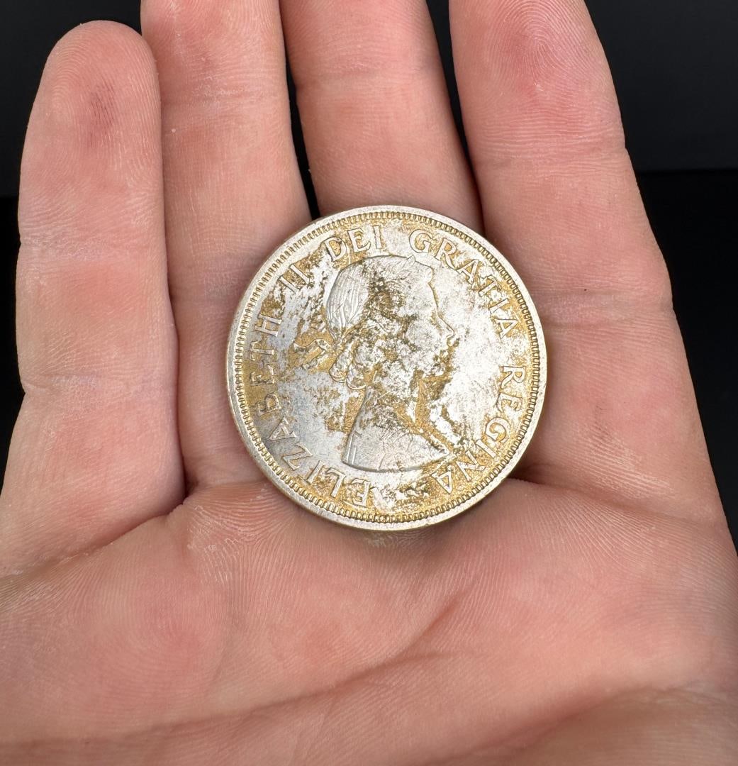 1964 Canada Silver Dollar: Has some surface discoloration and residual toning.