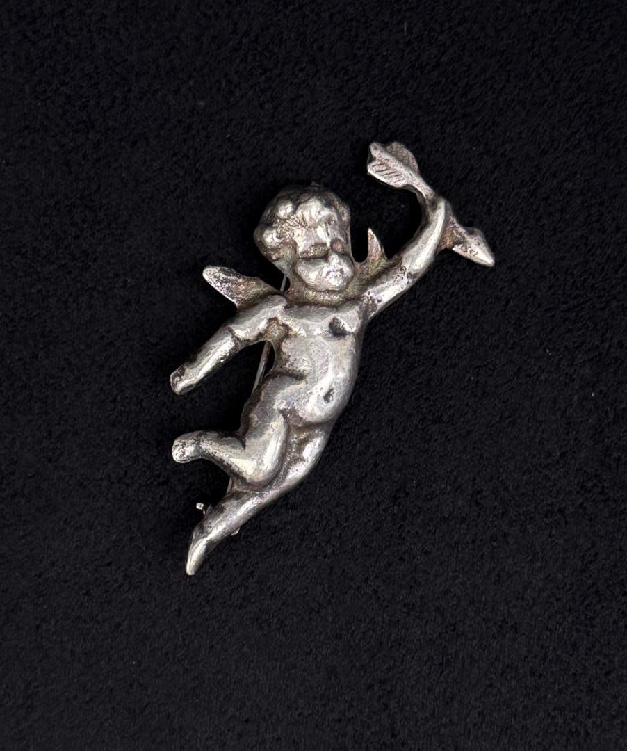 Sterling Silver Cupid with Arrow Brooch: 15.95 grams. 2 1/8" long.