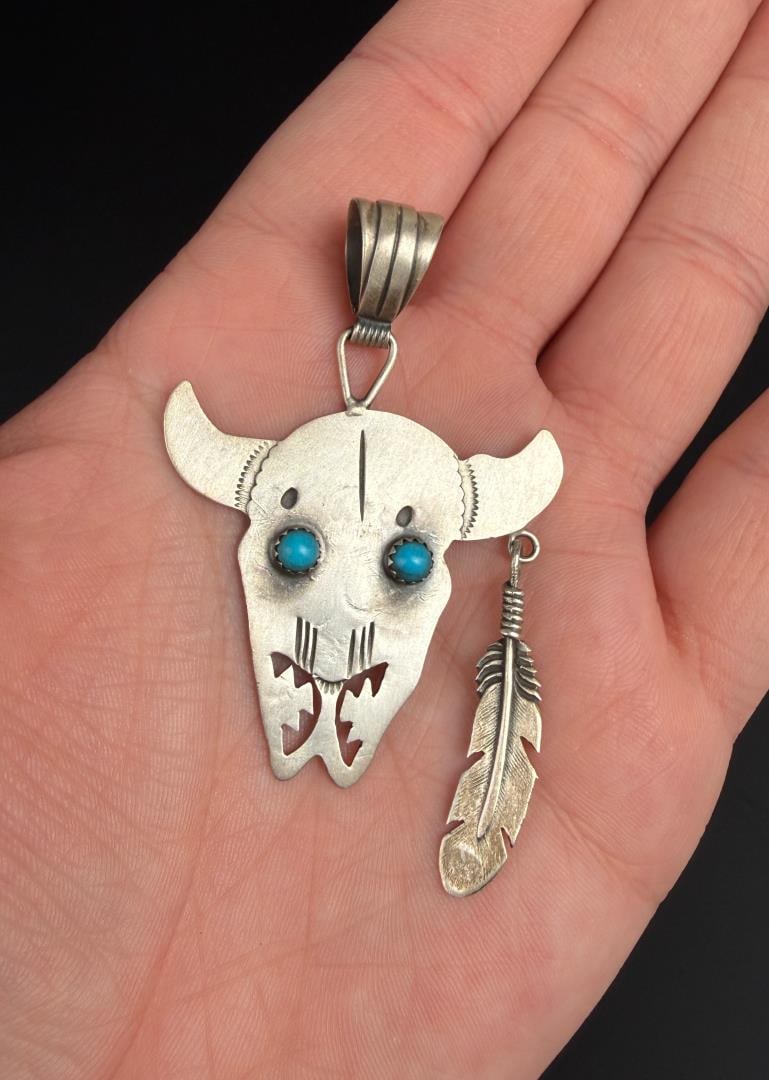 Running Bear Navajo Sterling Buffalo Pendant: 9.21 grams. Turquoise eyes. 2 5/8" by 1 1/2" by 3/8".