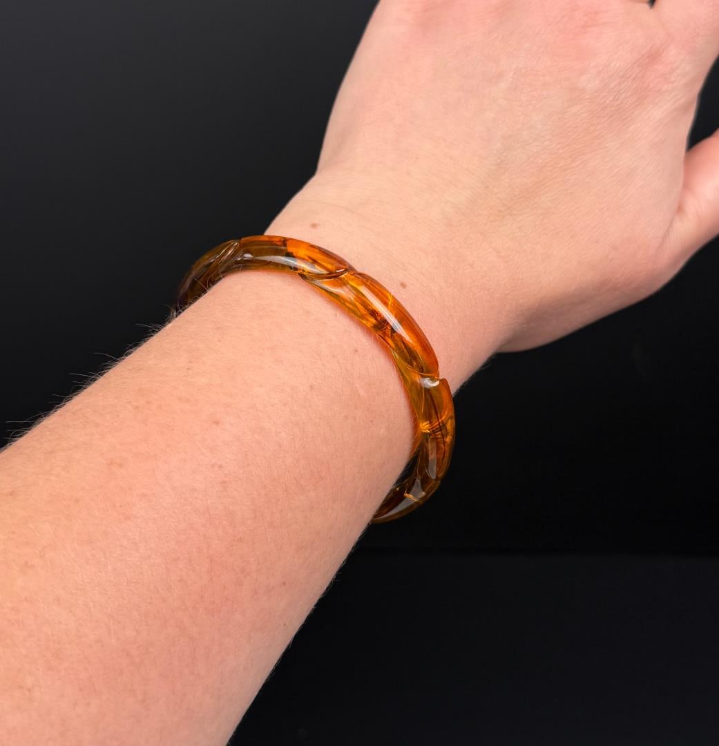 Carved Baltic Amber Scalloped Cuff Bracelet: 11.04 grams. Measures 7 3/4" in circumference.