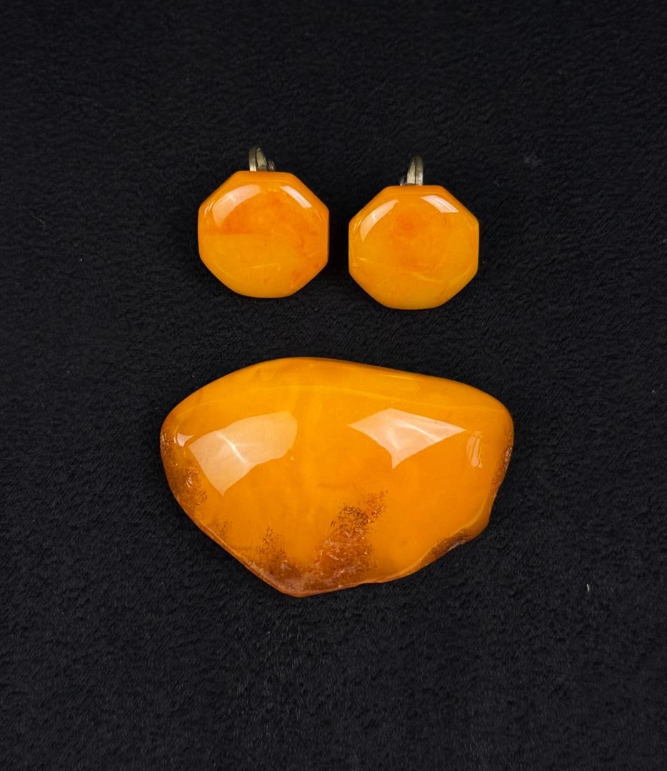 Baltic Amber Jewelry Set: Butterscotch and egg-yolk Baltic Amber pair of clip on earrings and a brooch. 21.99 grams. Brooch is 2 1/8" by 1 3/8" by 1/2". Earrings are 3/4" by 3/4" by 1/2".