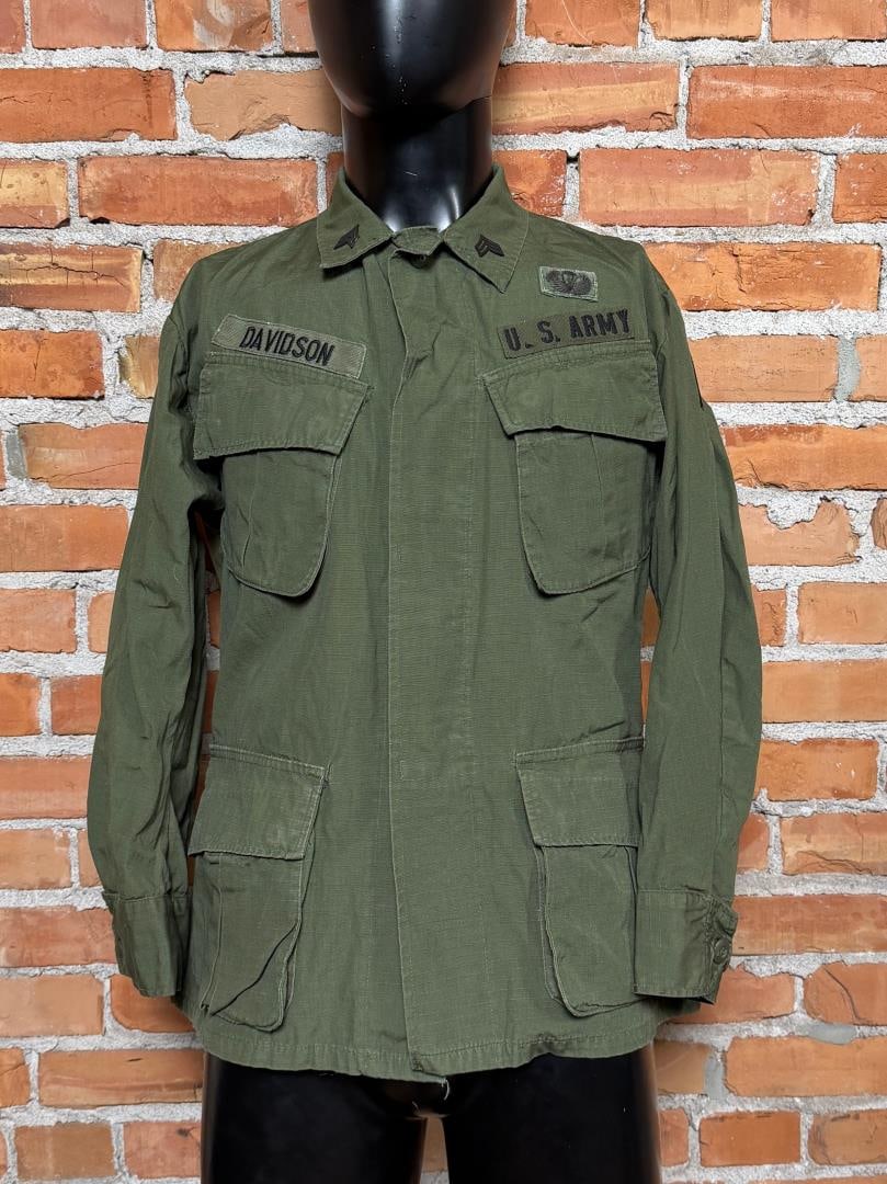 Named Vietnam War US Army Poplin Jungle Jacket: 3rd Pattern, manufactured in 1970 by Tellico Manufacturing company. Size small short. Worn by a U.S. Army Sergeant (E-5) and recipient of the Combat Infantryman Badge.