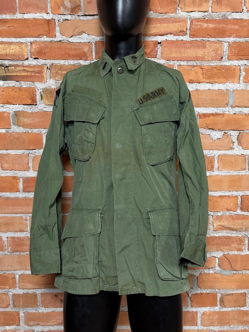 Vietnam War US Army Poplin Jungle Jacket: 4th pattern, manufactured in 1969 by Tellico manufacturing company. Size is small short. Patches show that the jacket belonged to a U.S. Army First Lieutenant (O-2), Infantry, assigned to I Field Forc