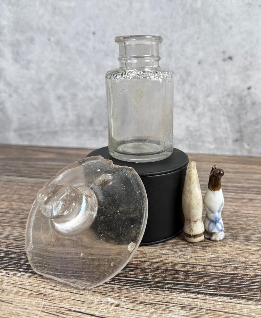 Civil War J.W. Crowdus Drug Co Bottle: Lid is 3 1/2" wide. Includes two pieces of porcelain doll limbs. Provenance: EX-Texas Civil War Museum, Fort Worth TX.