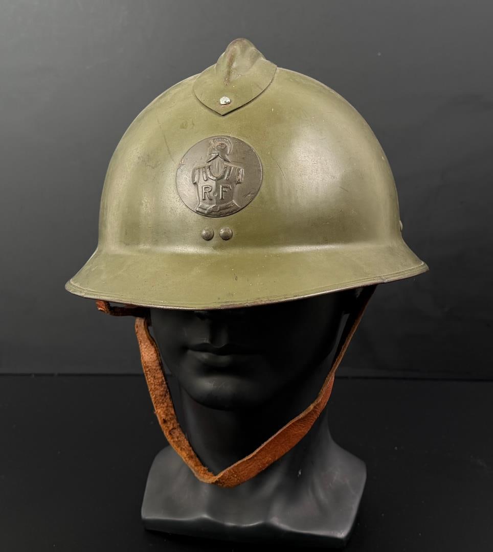 WW2 French M26 Adrian Combat Engineer Helmet: Nice example with liner and chinstrap. M1926 French Helmet with a Model 1937 Rondache military engineer badge.