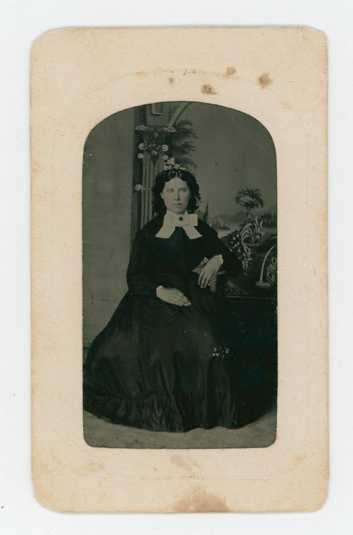 Antique Post Mortem Woman Tintype Photo: 2 1/2" by 3 7/8". Black Dress with White Cuffs and Collar. Taken at Smead's Rooms in Bellefontaine, Ohio.