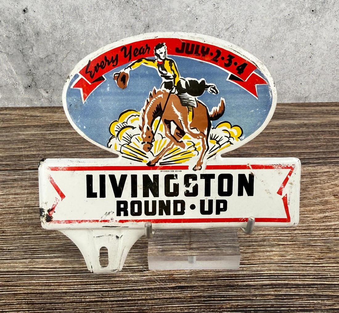Livingston Montana Round Up License Plate Topper: 5 1/4" by 6 3/8". Nice topper commemorating the Livingston Round Up Rodeo that takes place every summer on the 4th of July Weekend. Manufactured by Erickson of Des Moines, Iowa.
