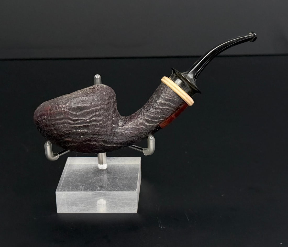 Stanwell Briar Estate Tobacco Pipe: Sandblasted bent tomato shape. N1 designed by Nanna Ivarsson. Handmade in Denmark. Measures 5 3/5" long.