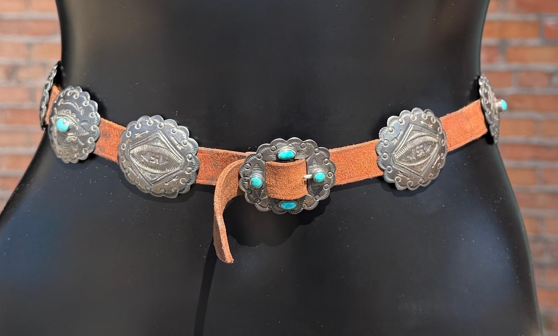 Swastika Whirling Log Navajo Sterling Concho Belt: Fred Harvey Era. 96 Grams not including leather. 28 1/4" long from tip to tip.
