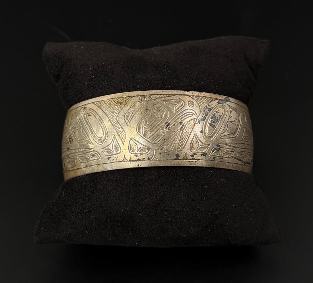 Northwest Coast Sterling Silver Raven Bracelet: Signed as shown. 33.61 grams. 6 1/4" inner circumference.