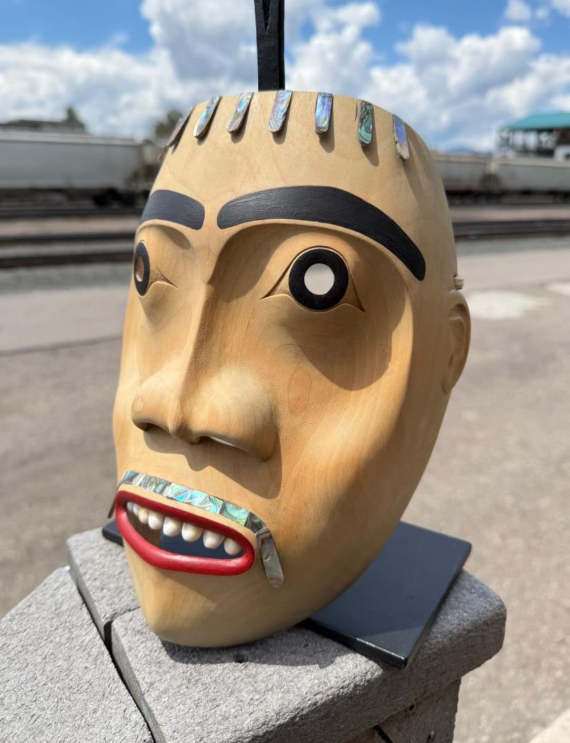 Gerry Dudoward Tsimshian Northwest Coast Mask: Title is Ice Son of the North Wind. Missing a piece of the top left part of the mask. 9 3/4" by 7 5/8" by 3 1/2". Gerry Dudoward was an outstanding Tsimshian carver. Over the years he developed a dist