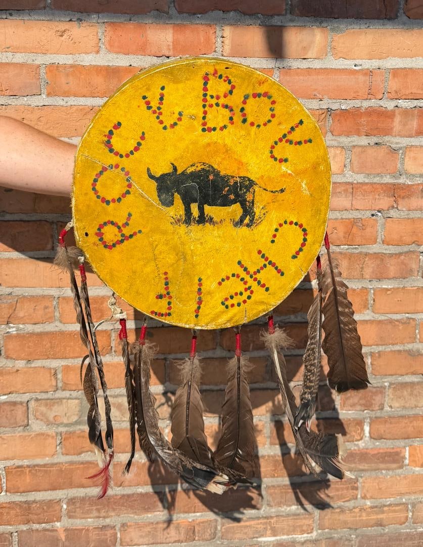 Rocky Boy Reservation Montana Indian Drum: 18 1/2" diameter by 29" long with feathers. Turkey feathers in trade cloth wraps. Buffalo Hide Drum has been patched at some point. First Half of the 20th Century.