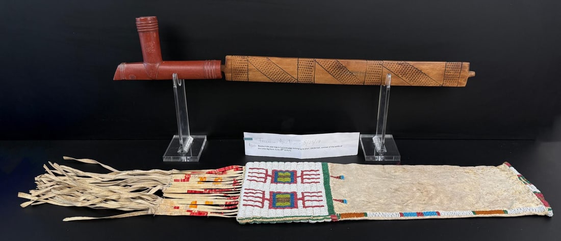 Indian Chief Iron Hail's Peace Pipe and Pipe Bag: Museum collection number on base. Bag is 33 1/4" long. Pipe and Bag date to the Battle of the Little Bighorn time period. Provenance: Freemans Auction 5/23/17, incorrectly identified as belonging to O