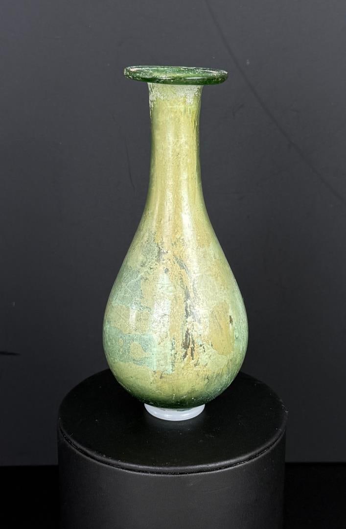 Ancient Roman Glass Unguentarium Perfume Bottle: 4 5/8" tall, 2" diameter. Provenance: From the estate of Andrew Cunningham Ware. Andrew Cunningham Ware Collection (1945?2024), South Florida. Formed mainly in the 1990s?2000s, the collection reflects