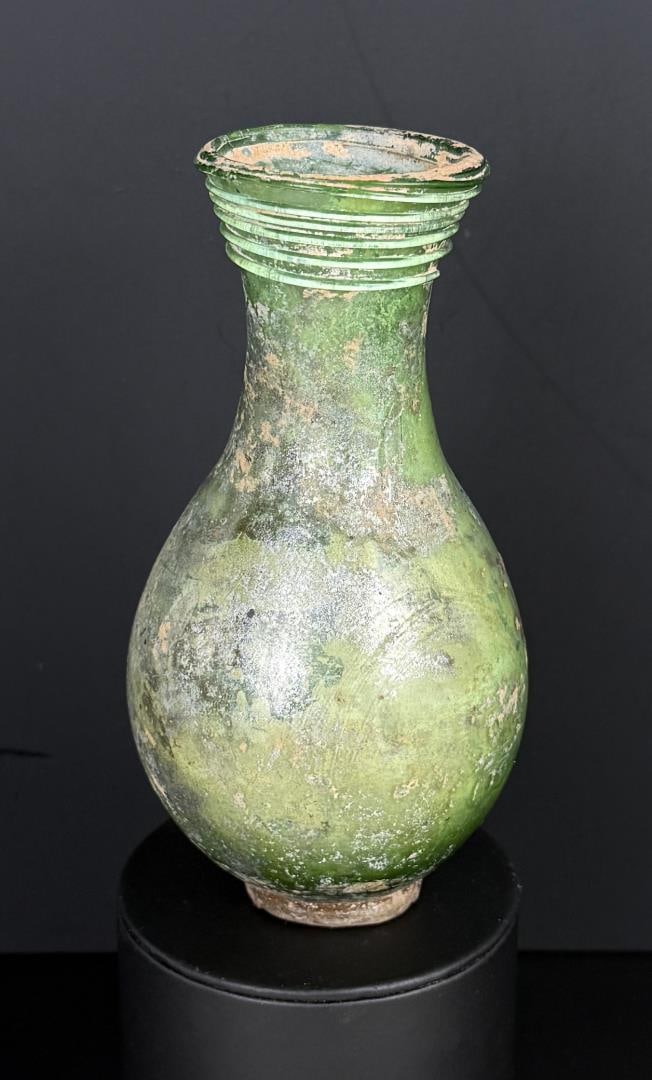 Ancient Roman Glass Unguentarium Perfume Bottle: 5 7/8" tall, 3" diameter. Provenance: From the estate of Andrew Cunningham Ware. Andrew Cunningham Ware Collection (1945?2024), South Florida. Formed mainly in the 1990s?2000s, the collection reflects
