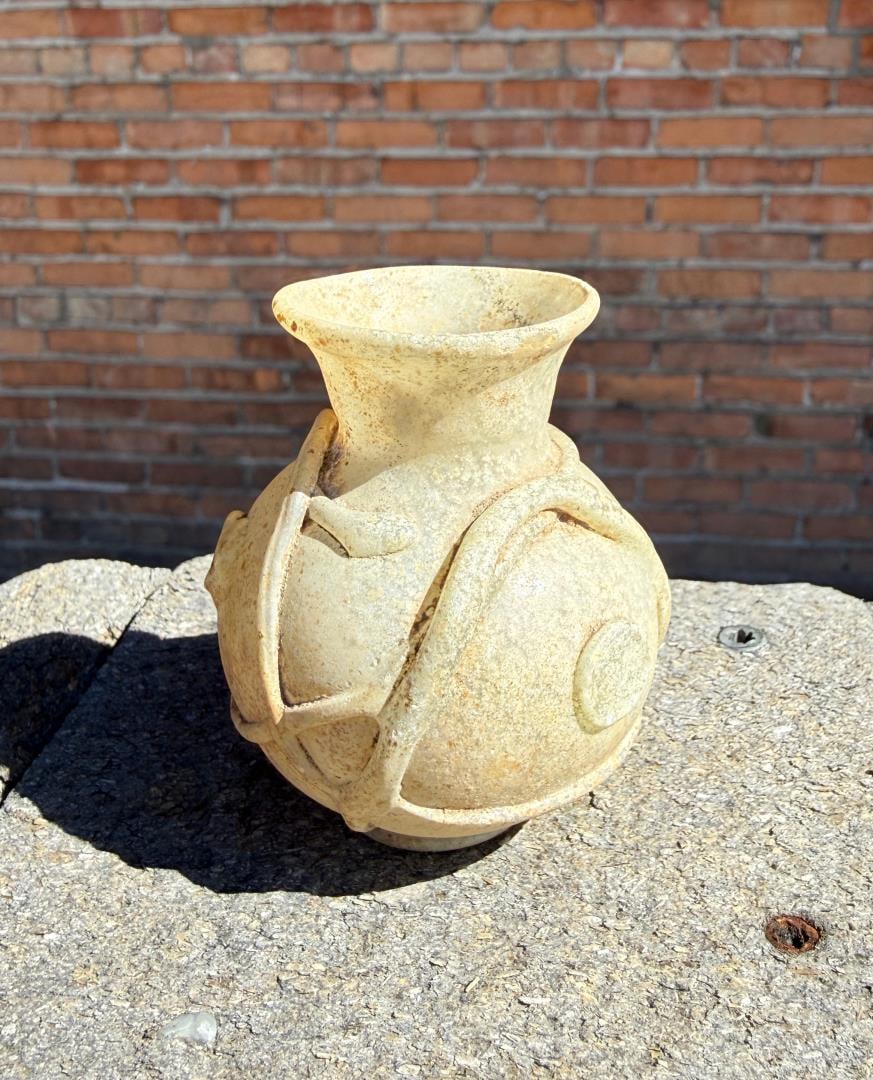 Ancient Roman Glass Bottle with Applied Decoration: 2 1/2" tall, 2 1/8" diameter. Provenance: From the estate of Andrew Cunningham Ware. Andrew Cunningham Ware Collection (1945?2024), South Florida. Formed mainly in the 1990s?2000s, the collection refl