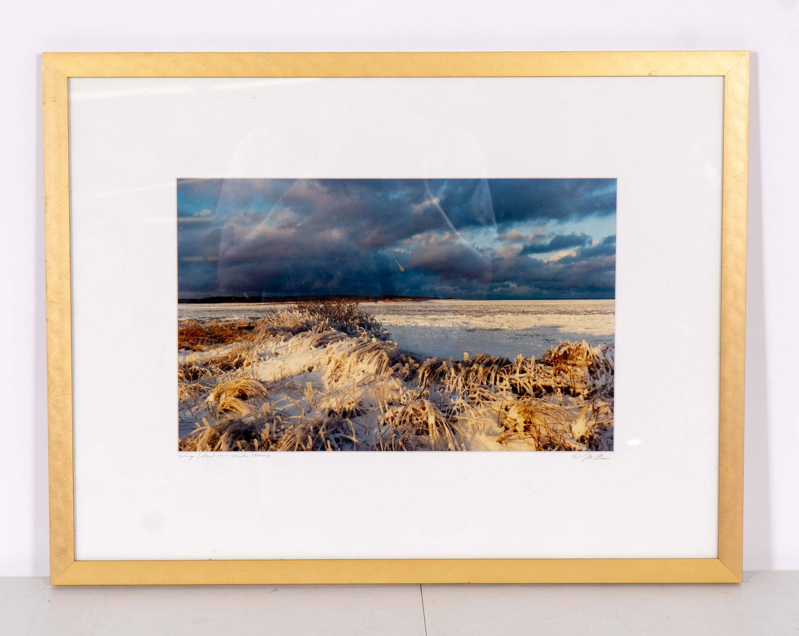 Signed Color Photograph 'Wing Island on a Winter: Color photograph of ice-covered coastal dunes, titled 'Wing Island on a Winter Morning' and signed Mark Preu in pencil in the lower margin, presented in a wooden frame with white matting. Minor spot o