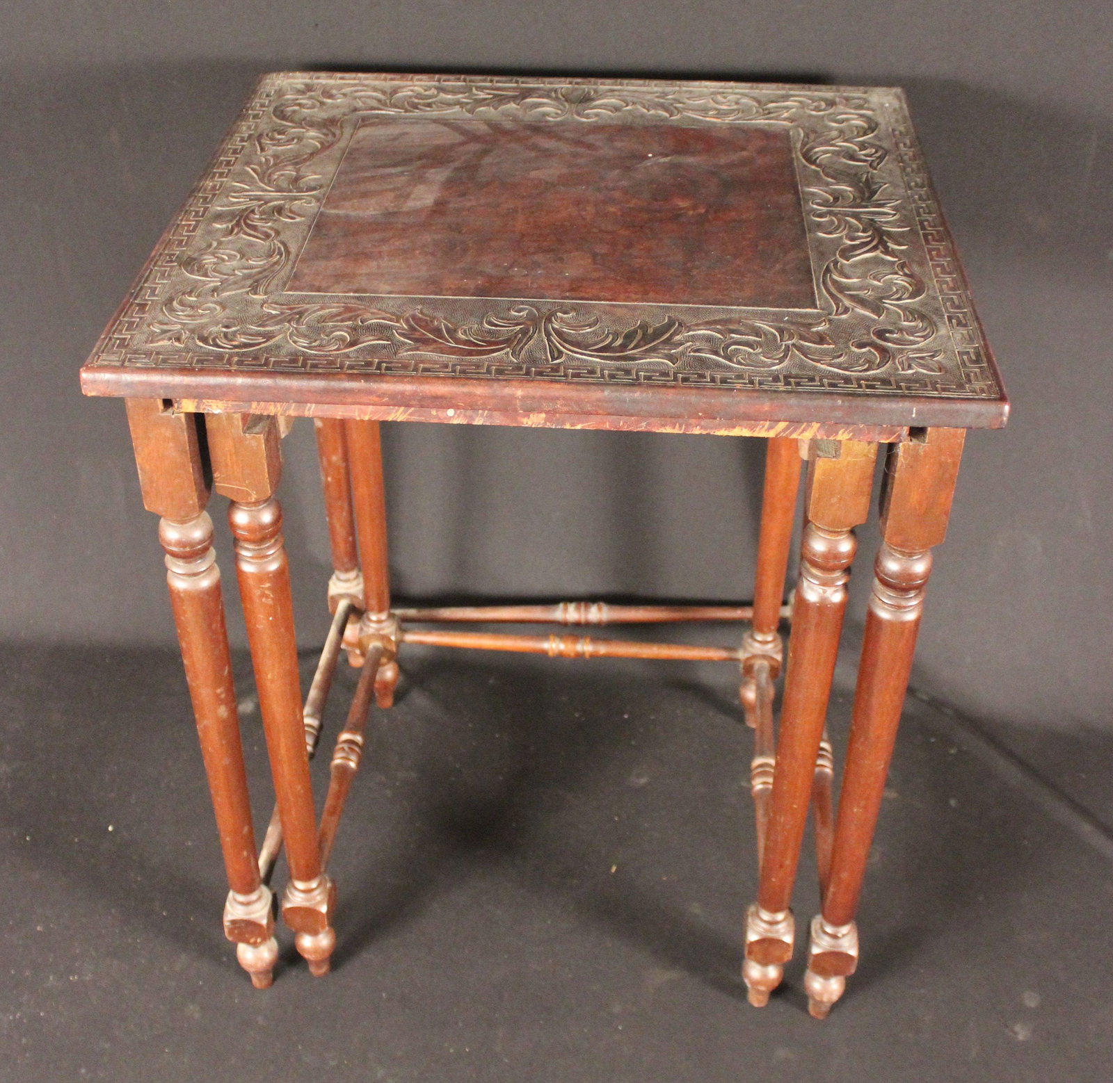 SET OF 2 MAHOGANY NESTING TABLES: Set of 2 Carved Leather Top Mahogany Nesting Tables. Condition used consistent with age. (the 3rd table is missing), larger table has minor staining. Size 23.5" H x 18"D x 20"W