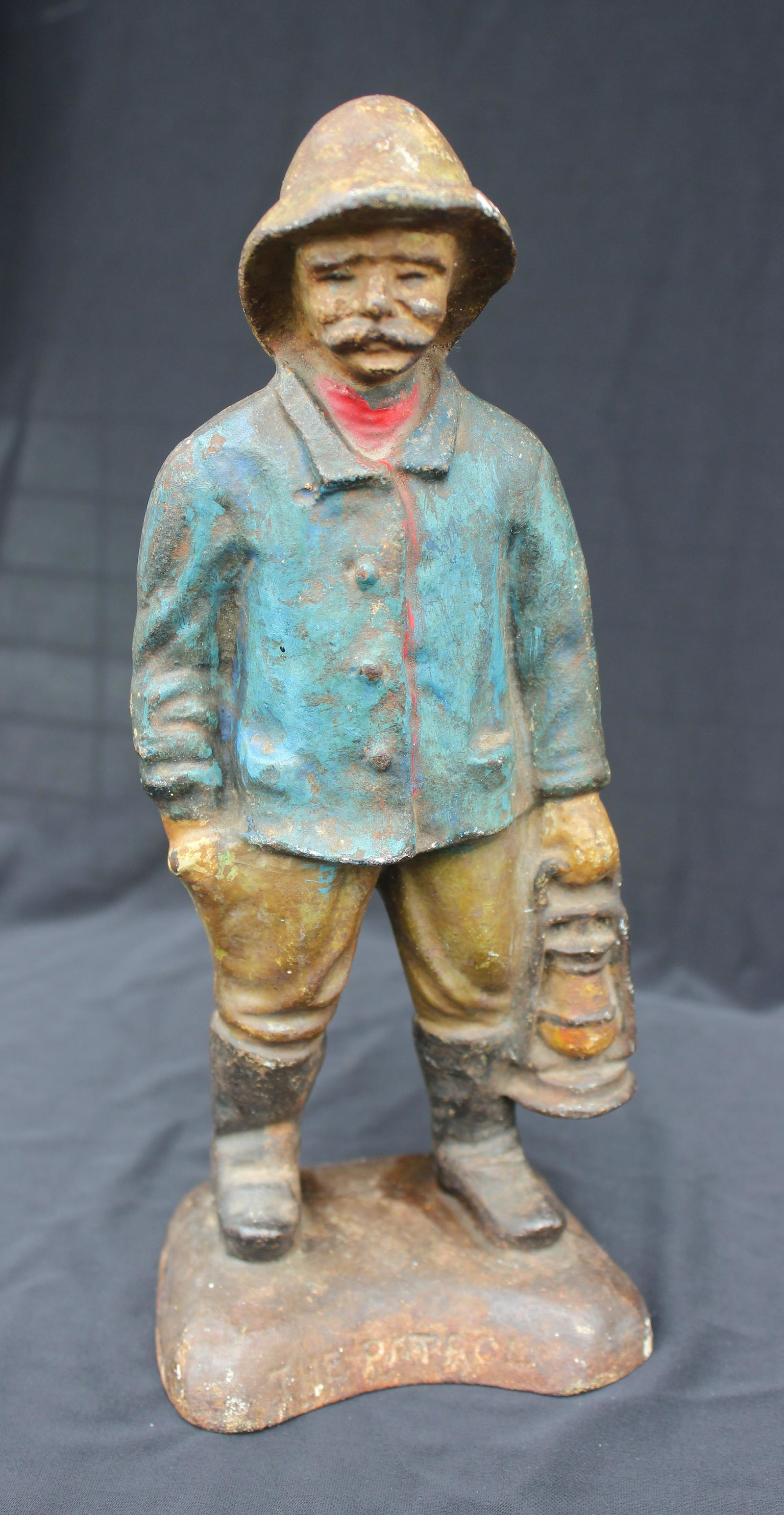 THE PATROL CAST IRON DOORSTOP: Early 1900's cast iron doorstop, it depicts an elderly gent wearing a rain slicker and carrying a lantern. These folks would walk the beach during inclement weather to warn ships off the rocky coastli