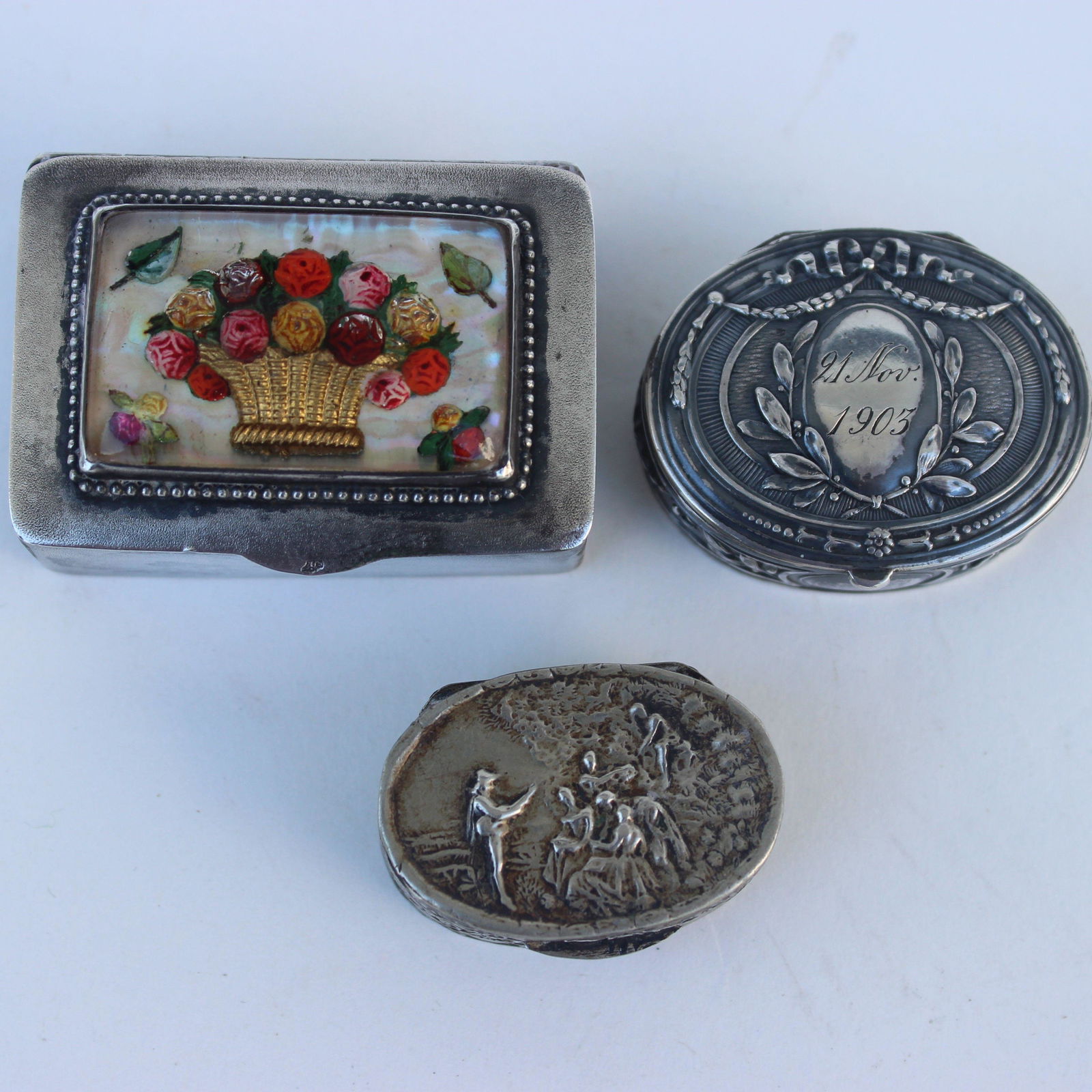 (3) CONTENENTAL SILVER SNUFF BOXES: Oval snuff box with bough & wreath design dated Nov 21, 1905 is marked on the inside lid 800 with touch marks, 1.5" , .375 troy ounces, oval box genre scene marked Italy no other markings probably pla