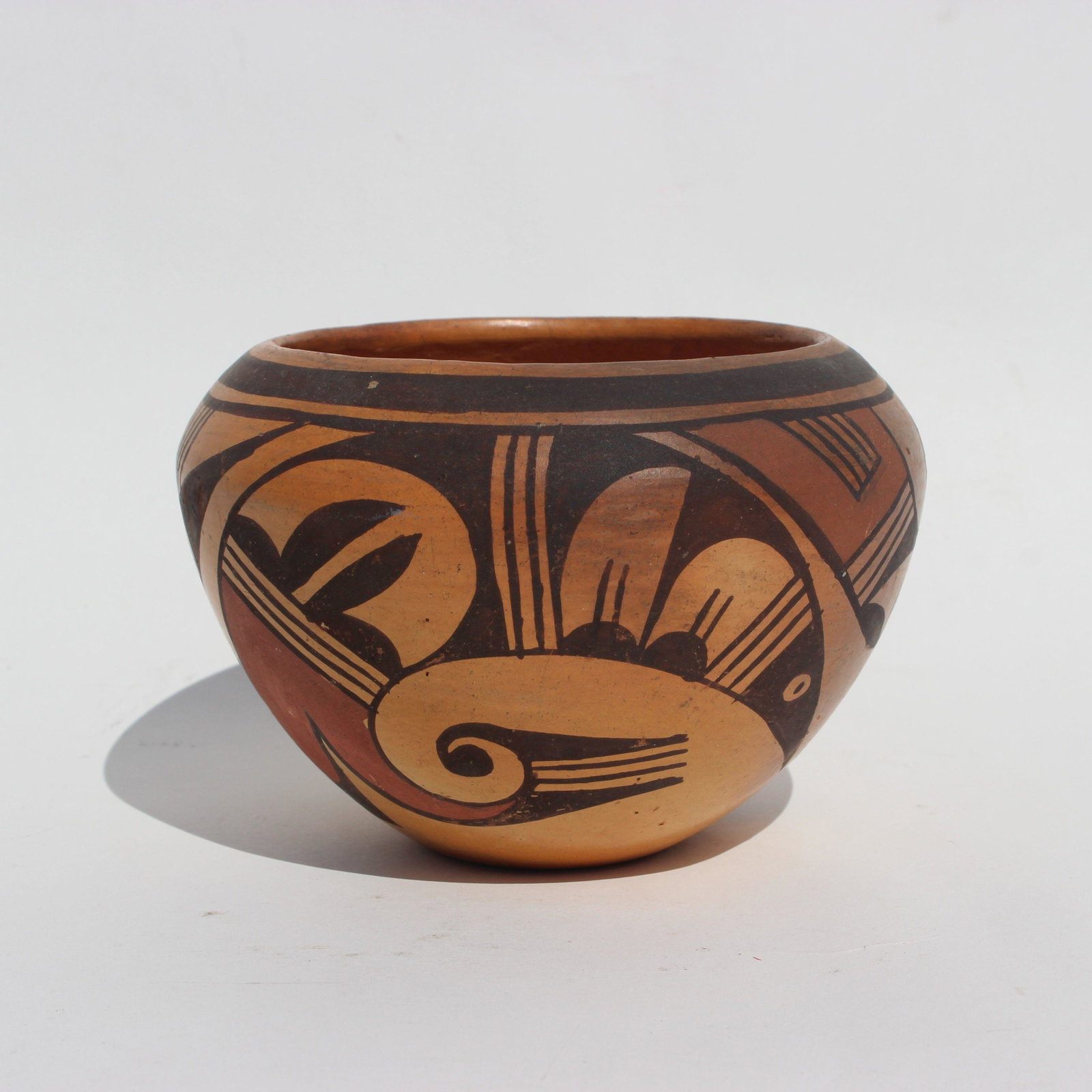 HOPI POTTERY BOWL BY THERESA HARVEY: Hopi polychrome pottery bowl in browns & yellow-orange early/Mid 1900s. A classic vintage polychrome bowl with traditional avian motifs. Good condition, some scuffs and dark areas, shows use, consiste