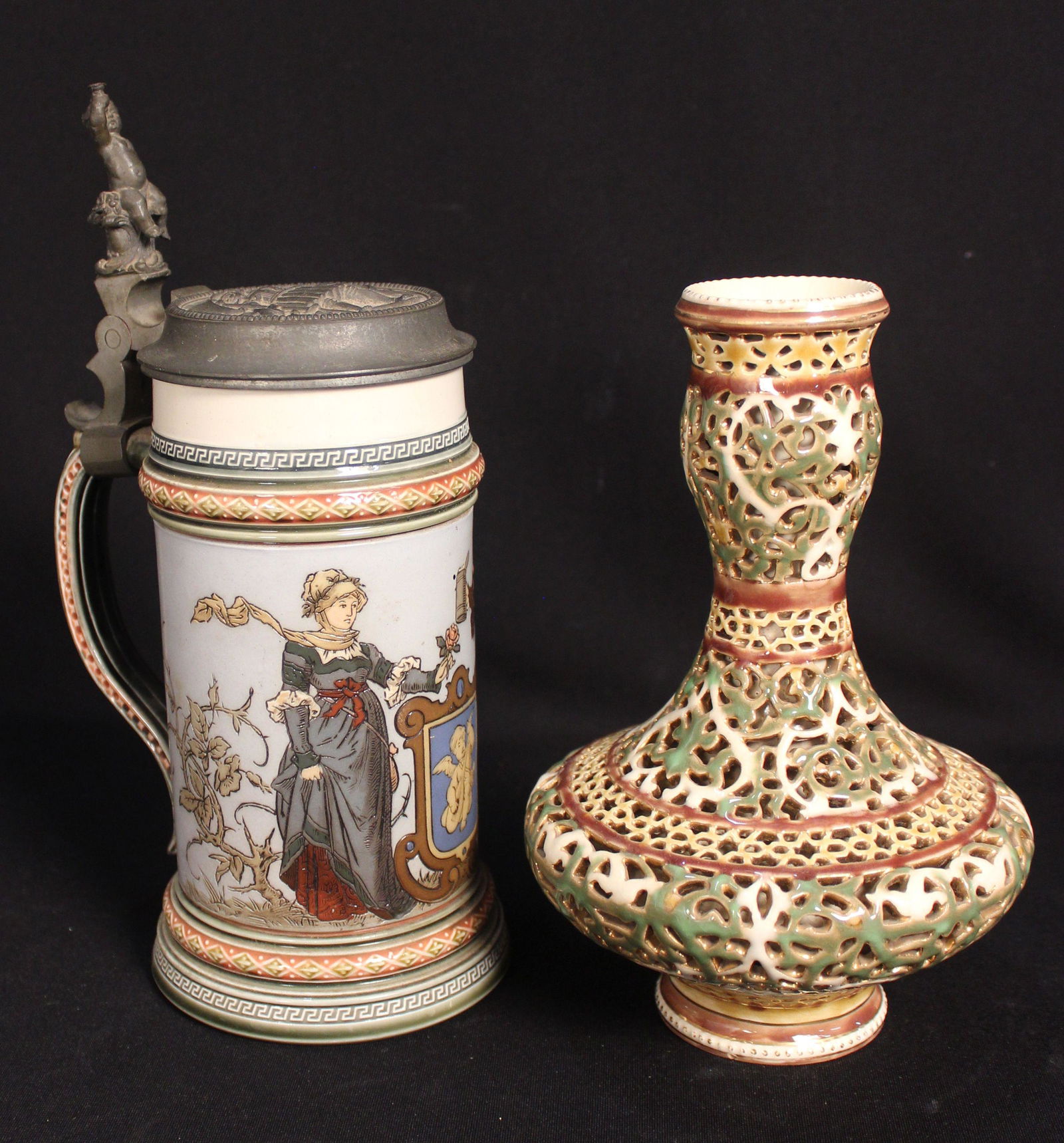 METTLACH STEIN & ZSOLNAY VASE: German stein with pewter top the stein measures 7.25", overall 10". The vase has reticulated grillwork 8" height.