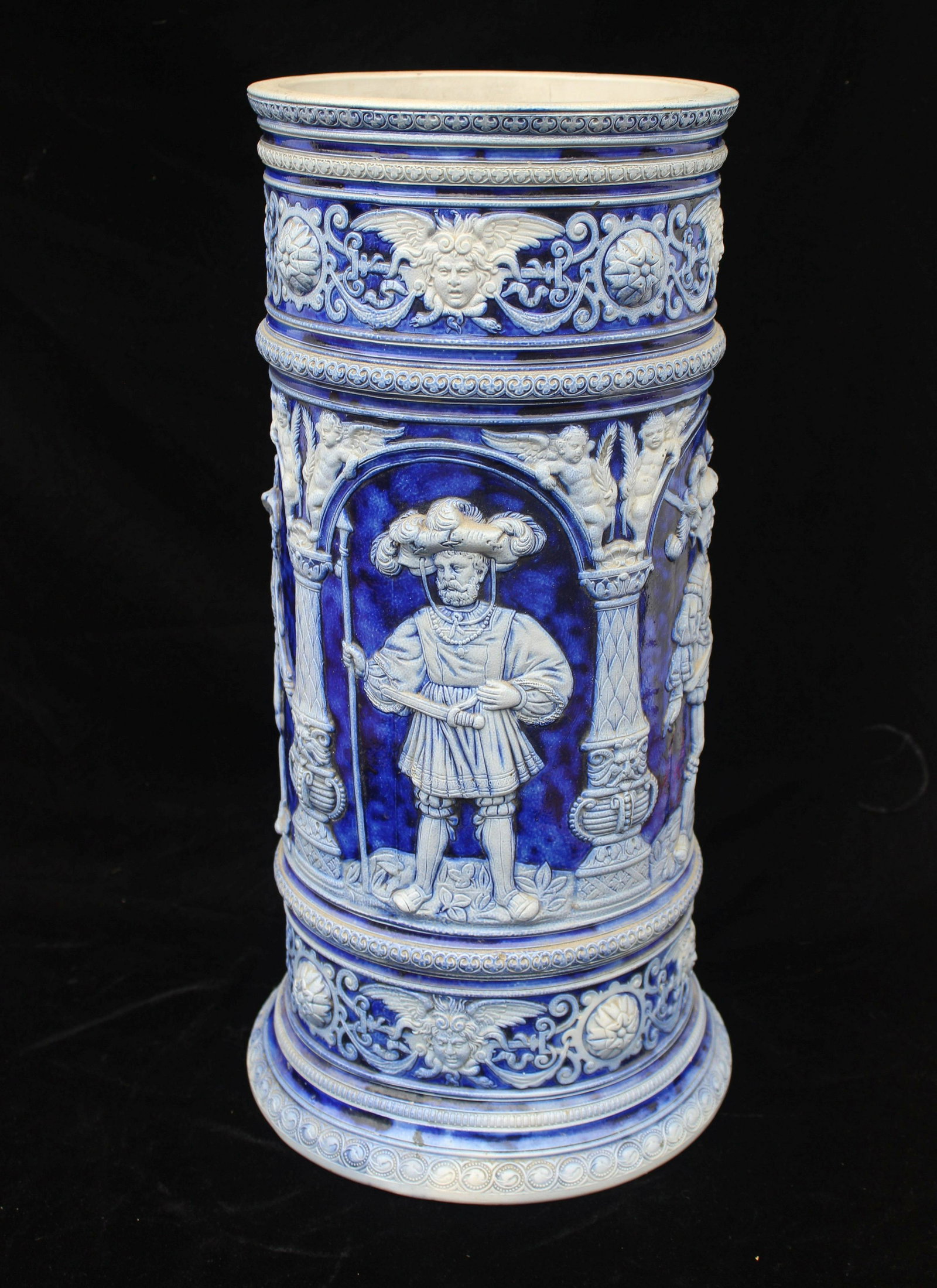 19TH C BAS RELIEF GERMAN CERAMIC UMBRELLA STAND: Cobalt blue color, marked 931 under base. Condition is good consistent with age. Size 23.5" H