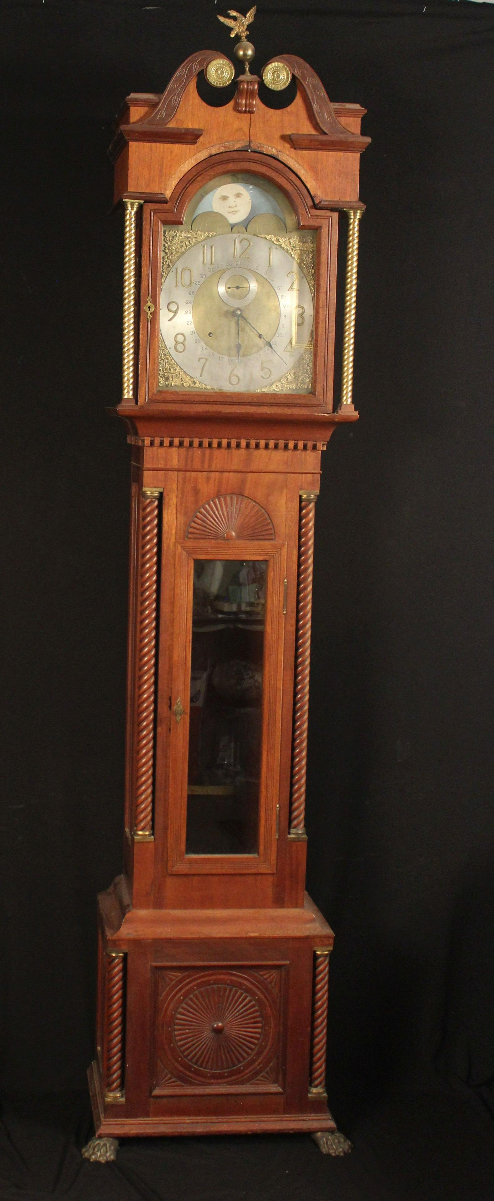 AMERICAN TALL CASE CLOCK: Custom mahogany case with brass hardware, Seth Thomas brass works, dial & painted moon phase. This clock is made up of different parts and pieces late 19th c with restorations has weights & pendulum.