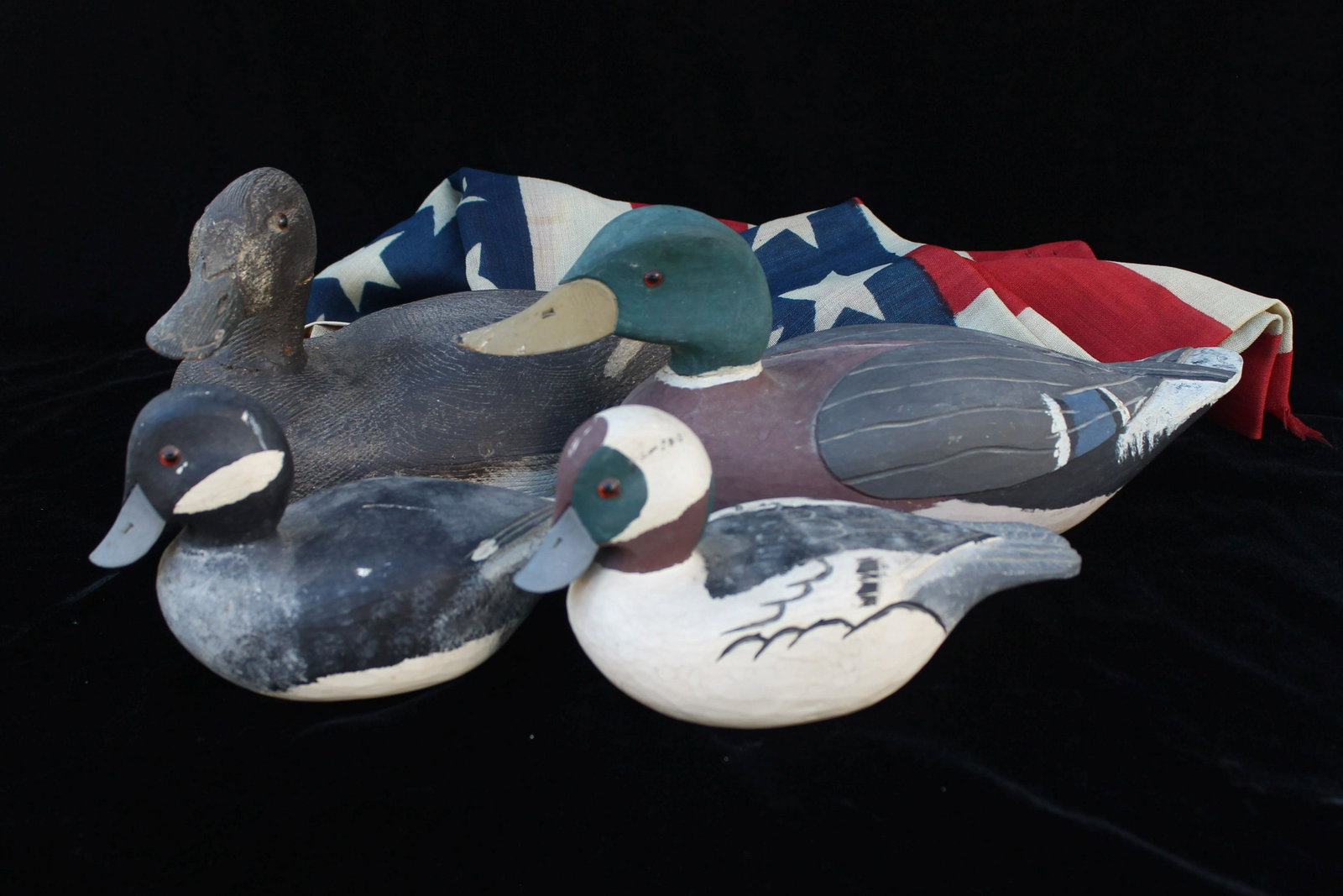 4 CARVED DECOYS & AMERICAN FLAG: The American flag has 40 stars on printed linen, condition torn edges. size 36" x 55"