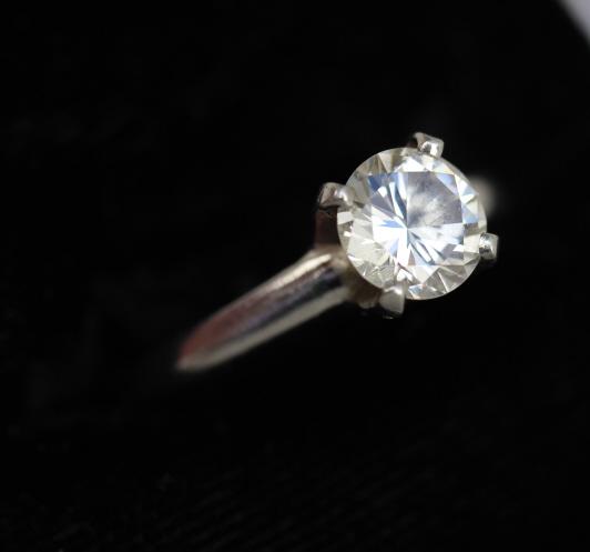 ESTATE PLATINUM DIAMOND SOLITAIRE RING: 14k platinum diamond solitaire ring. The diamond is a round brilliant /cut set in a high profile four prong crown and weighs .95cts estimate. Size 7.