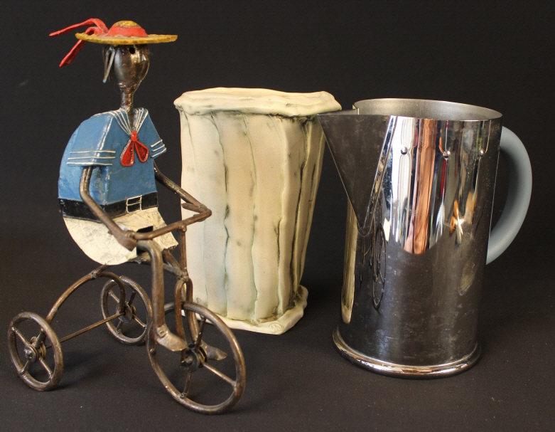 GROUPING OF ITEMS MICHAEL GRAVES ALESSI PITCHER: Italian Alessi chrome water pitcher 8.5". Hand crafted metal bicyclist artist signed 11" H. Pottery flower vase signed. 8.5"H. Consistent with age all pre-owned.