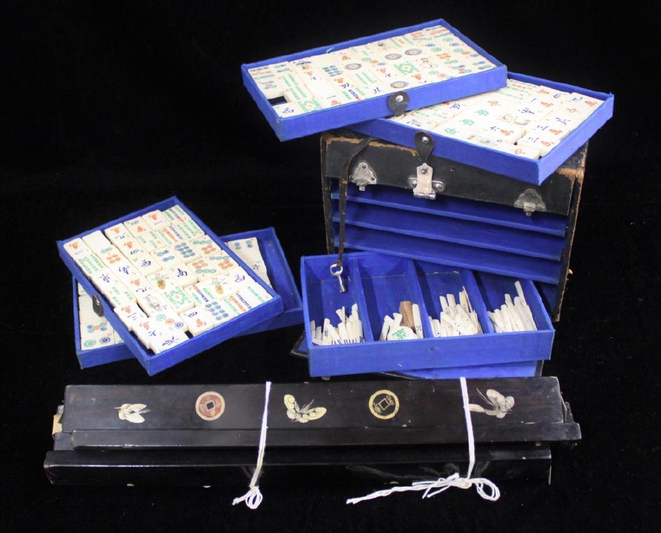 Vintage Mahjong Set: Carved bone tiles and game implements and four lacquered game tile holders.
