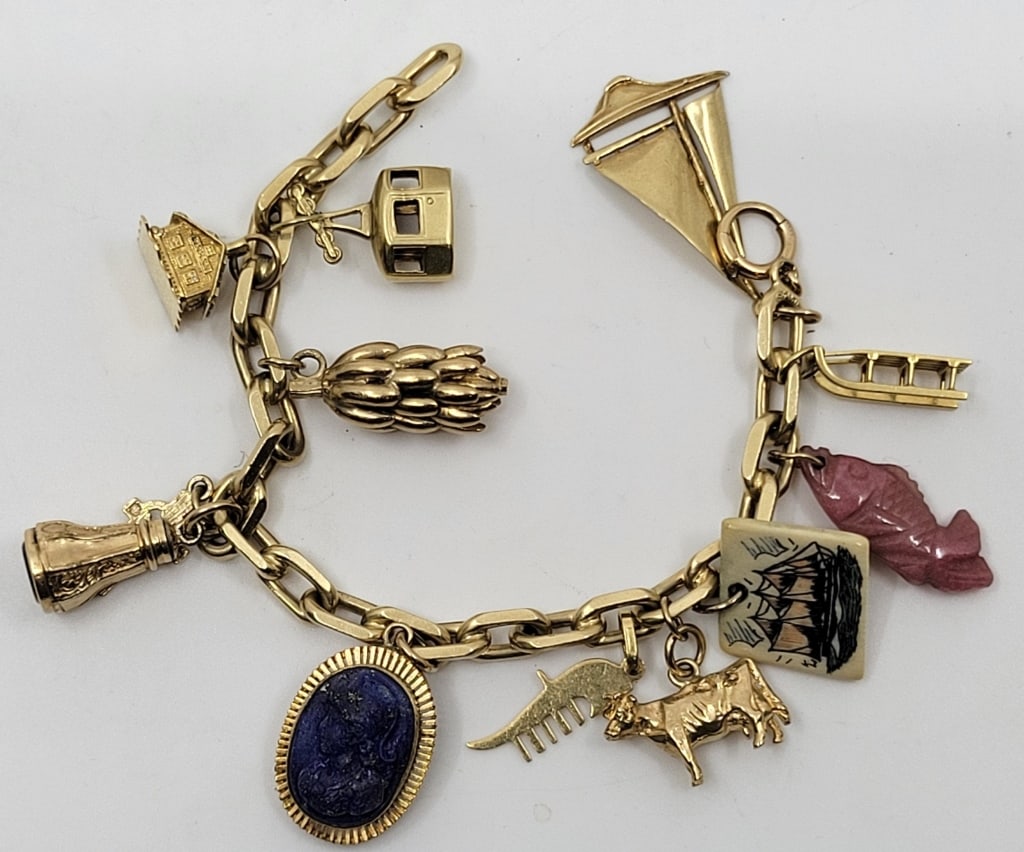 14K Yellow Gold Charm Bracelet: Approx weight 50 grams