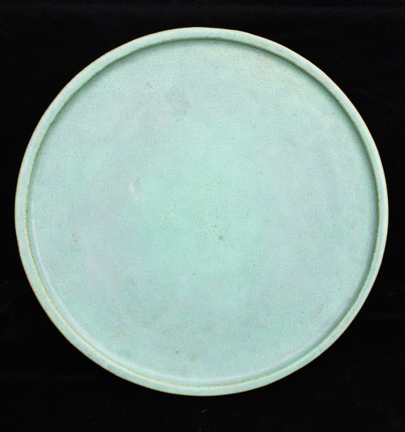 Teco Pottery: Teco Pottery under plate or tray. Matt green color, size .75" height x 10.5" depth, small flake on top edge see photo