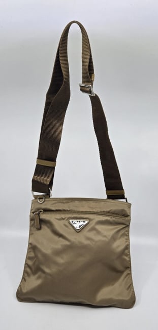 Prada Vela Sport Nylon Cross Body Bag: Prada Cross Body Vela Sport Nylon Bag, color tobacco adjustable shoulder strap with leather trim, metal triangle logo. Authenticity card #BT175Z. Size 8.5" height x 9.5" width. Condition very good.