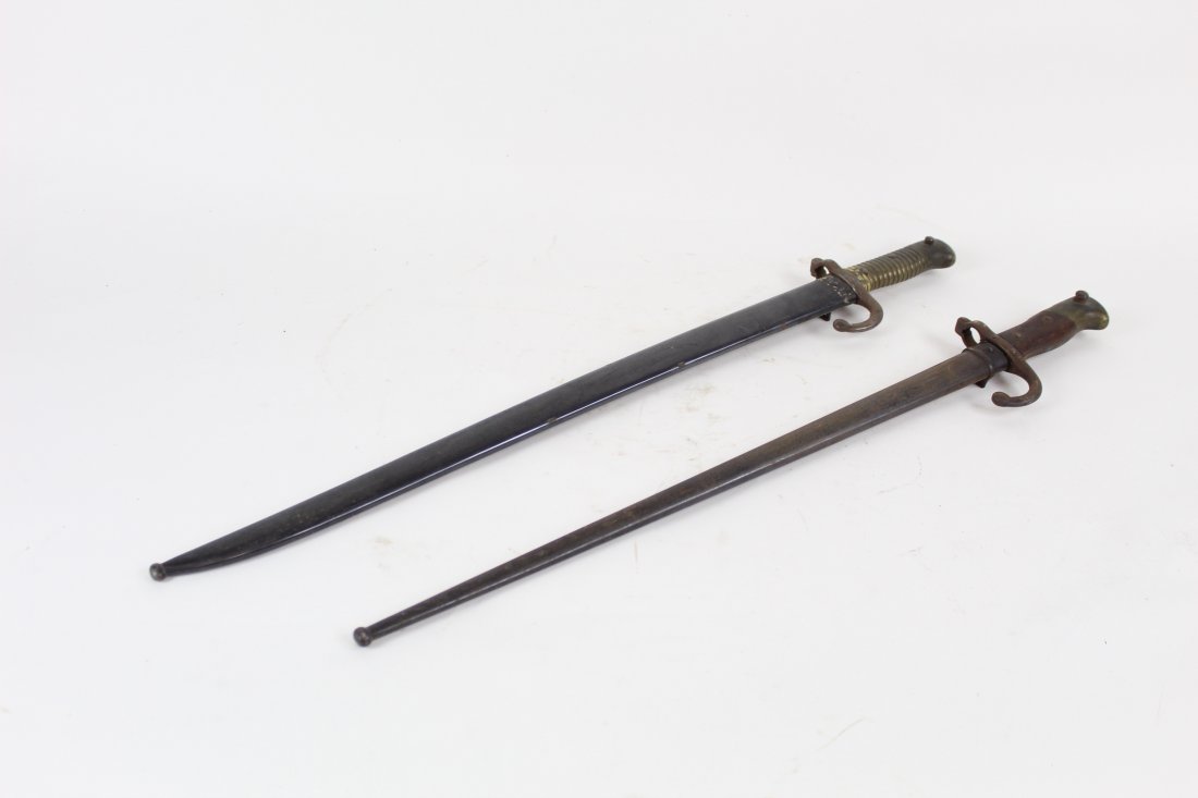 Pair of Bayonets: Pair of bayonets. One has a brass handle and one has a wood & brass combo handle. They have numbers and marks.Condition: excellent. call for additional condition report. Size: The larger is 28in long.