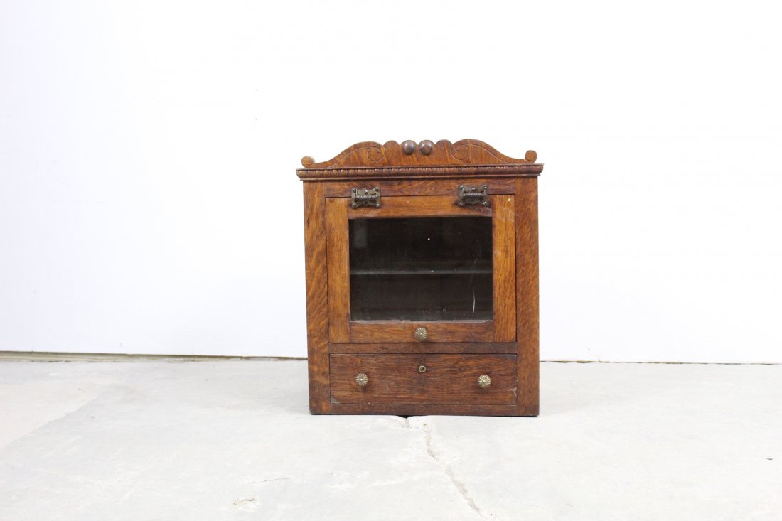 Oak Glass Front Lift-Up Door Medicine Cabinet: Glass front medical cabinet with single drawer. Lift top. Good Condition. Call for additional condition report. Measures 21"x18"10.75".
