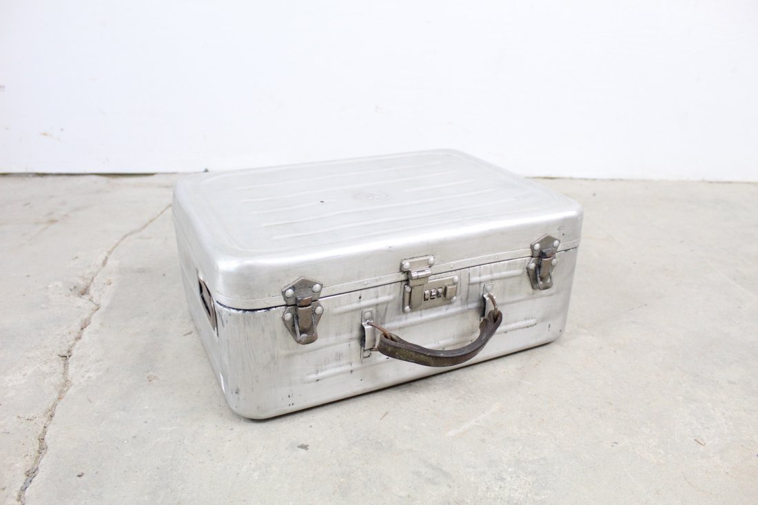 Naval Aluminum Suitcase With Great Industrial Look: Naval aluminum suitcase with a scroll lock on the front and an anchor on the top. The lock on the front seems broken but otherwise the suitcase is in good condition. Dimensions are 17.25 x 14 x 7.25in
