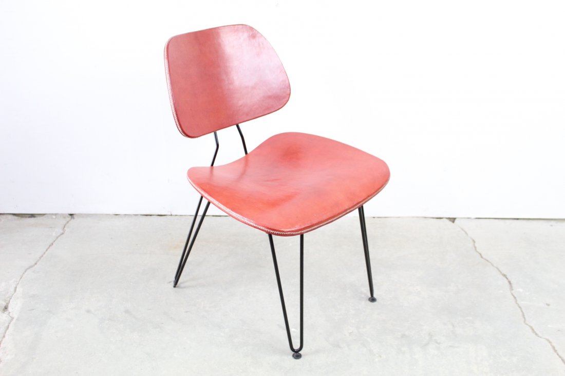 Red Leather Sol & Luna Chair with Iron Base: Single red leather chair with an iron base that would be a great pop of color to add to your home. The chair barely shows any wear and is in excellent condition. Made by Sol & Luna. Please call or ema