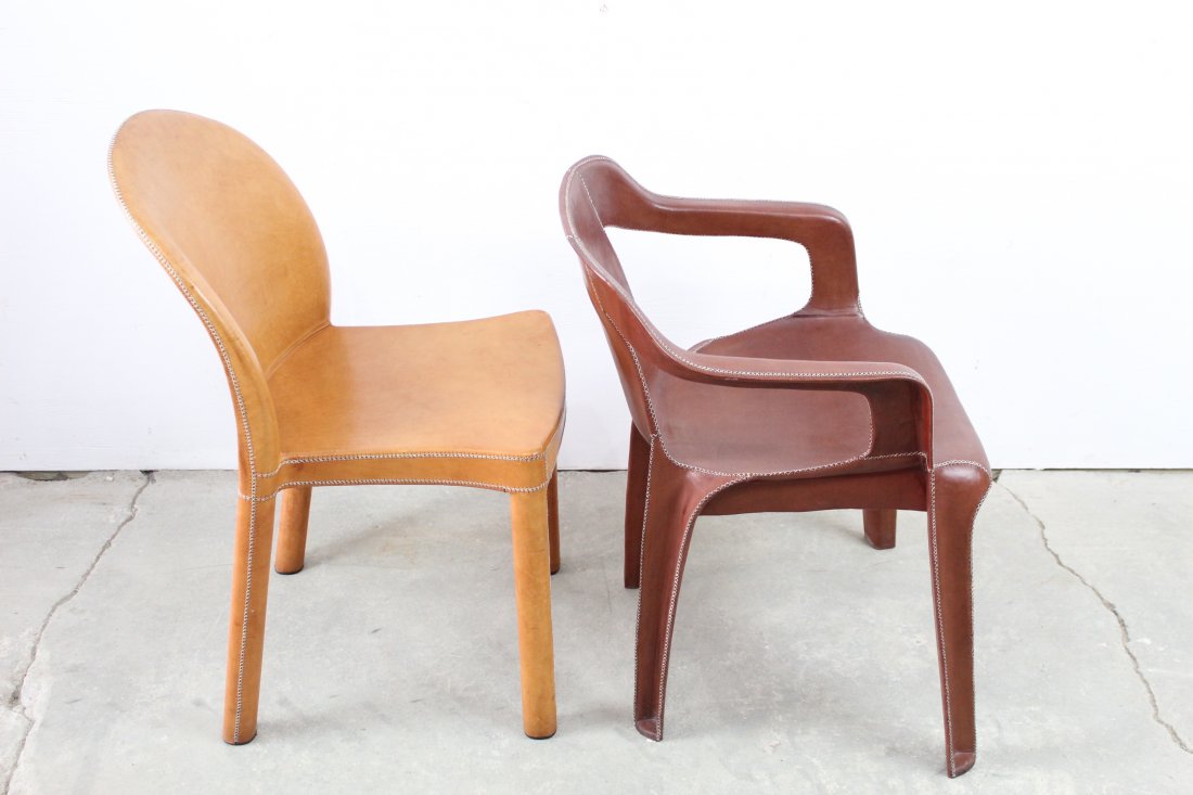 Lot of 2 Sol & Luna Leather Legged Chairs: Lot of 2 mismatched leather legged chairs that would add a great splash of color anywhere. One is red with arms and the other is tan/orange without arms. They look new and are in excellent condition. 