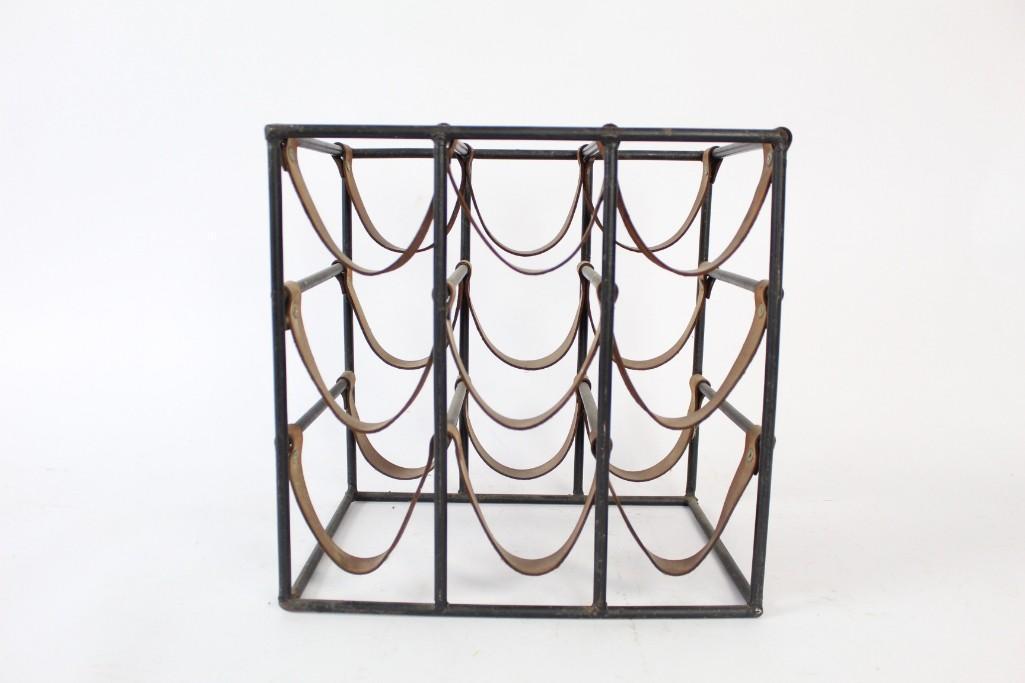 Arthur Umanoff Wrought Iron & Leather Wine Rack: Arthur Umanoff Wrought Iron & Leather Wine Rack. Mid-century Modern wine rack designed by Arthur Umanoff. Holds nine bottles in riveted leather straps between welded black metal armature. A minimalist