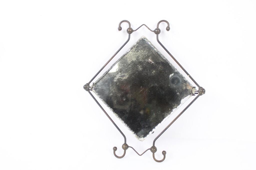 Small Standing Rippled Edge Mirror with Metal Frame: Small Standing rippled edge mirror with metal frame. This mirror may not be the best for checking your hair style, but it is still very pretty and would look great in any room. The decorative rippled 