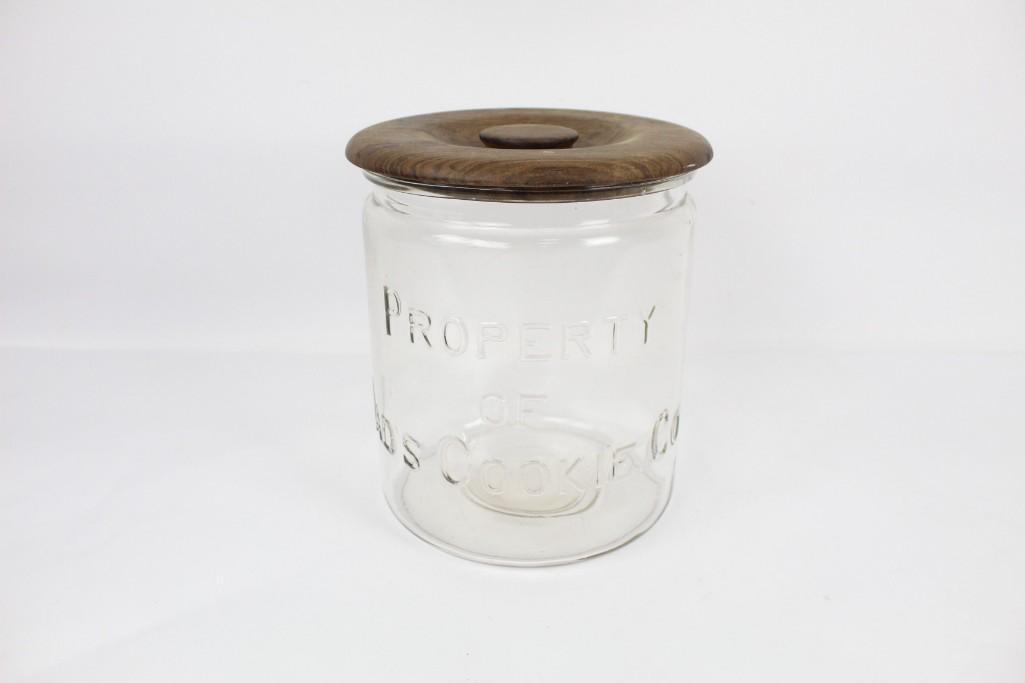 Large Glass Dad's Cookies Advertising Jar & Wooden Lid: Large glass cookie jar with wooden lid. This glass cookie jar will allow you to keep track of exactly how many cookies you have left- and thus how soon you have to run out to get more. It says "Proper