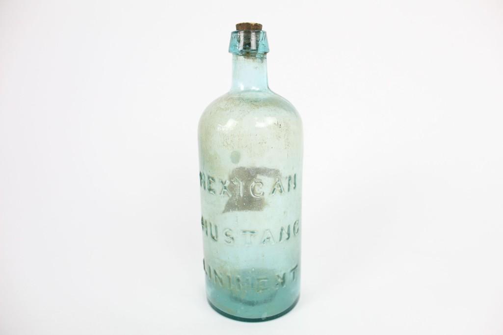 Antique 19th Cent Mexican Mustang Liniment Glass Bottle: Antique clear glass bottle, marked "MEXICAN MUSTANG LINIMENT." Google the term for a fascinating history of this Victorian-era cure-all whose main ingredient is suggested to have been crude petroleum.