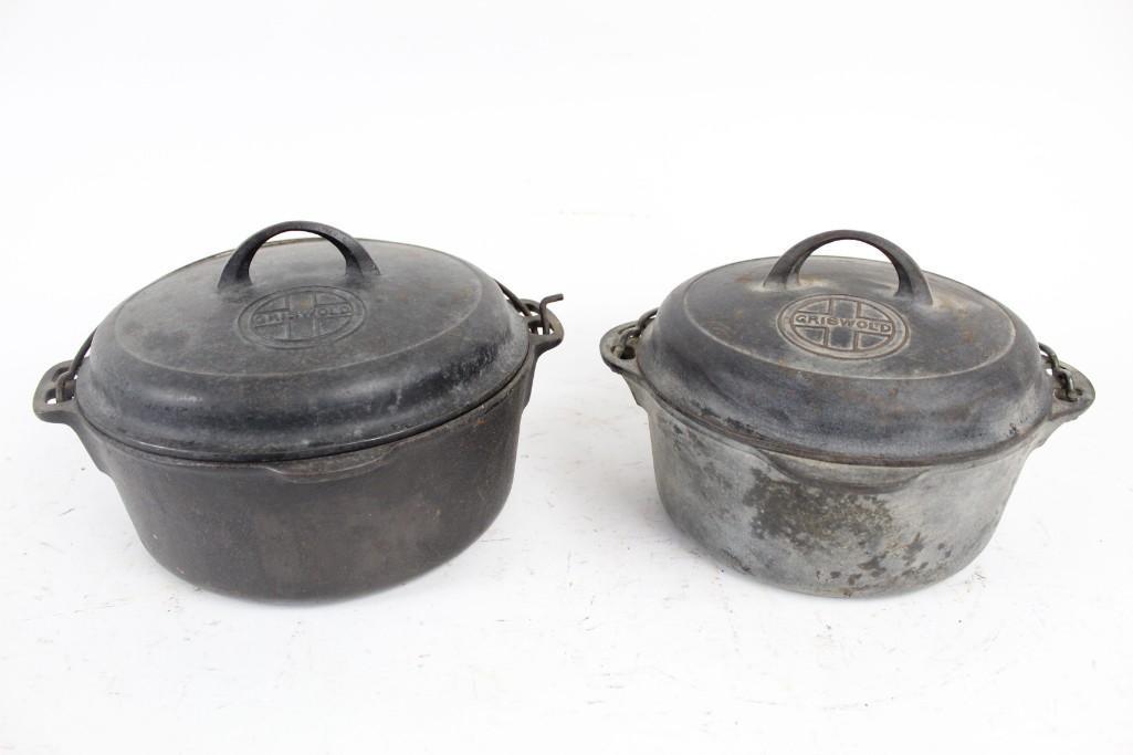 Pair Griswold Cast Iron Dutch Oven Pots, Lids Handles: A pair of vintage Griswold cast iron dutch oven pots sizes 7 and 8, with lids and handles. Would make great collector's items or pieces to be passed along as heirlooms in your family. The marking on e