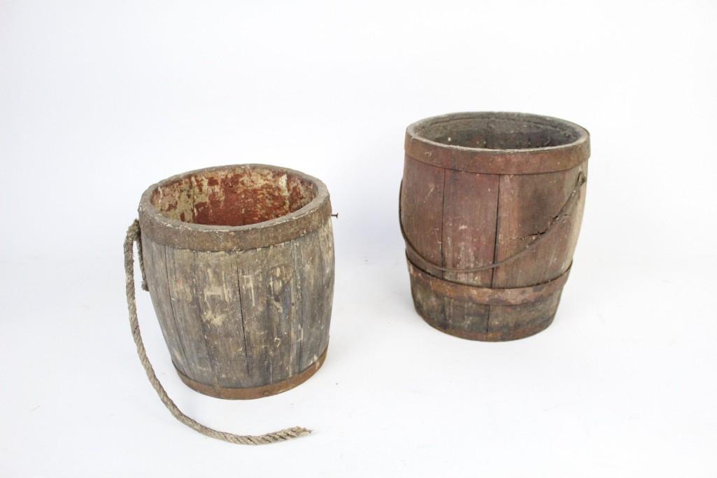 Pair of Antique Wooden Paint Barrels with Metal Bracing: Pair of antique wooden paint barrels with metal bracing. You can see remnants of paint inside of these wooden barrels. One of them is stamped with what appears to be the letters "DBD" on the bottom.&n